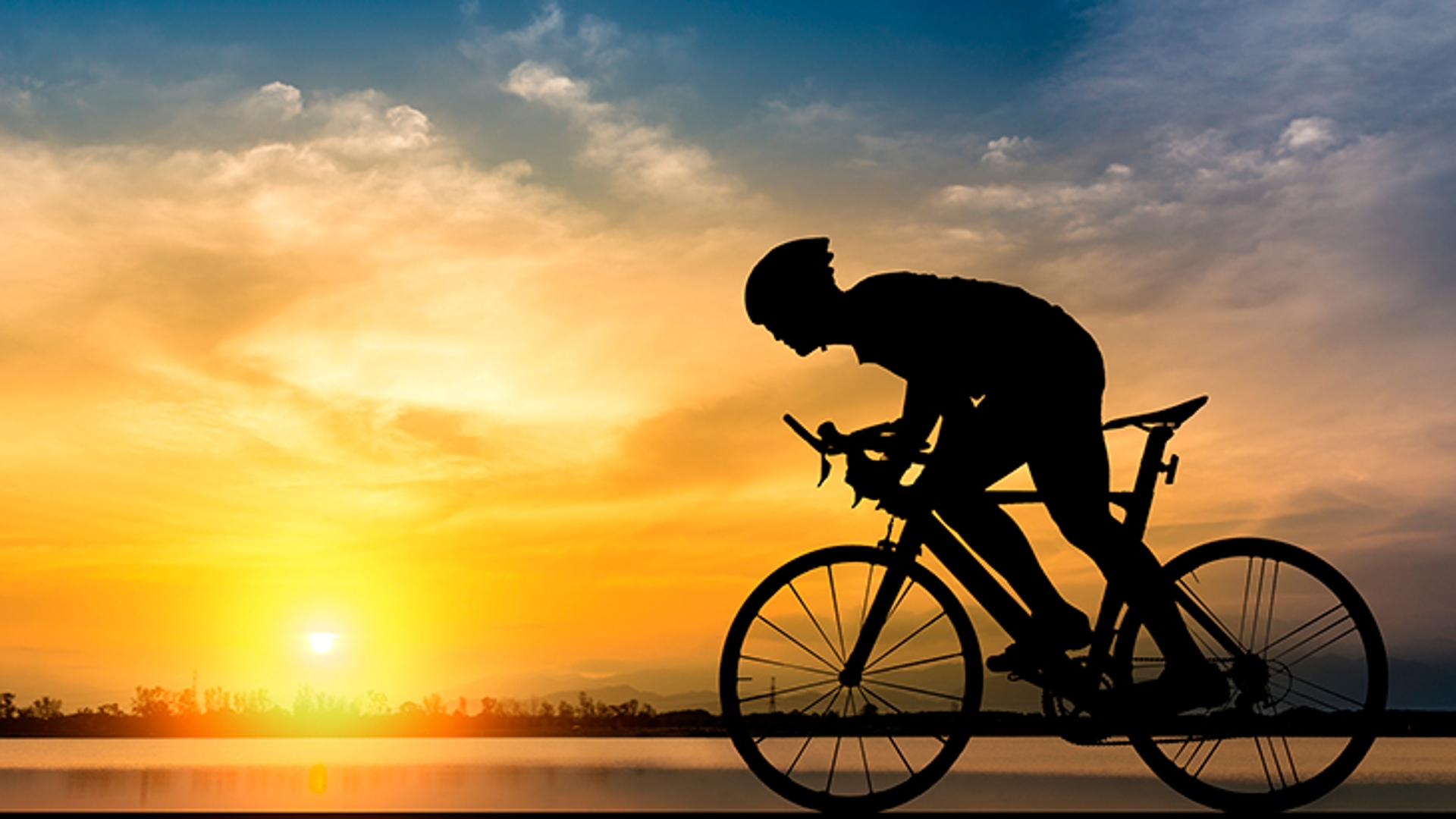 Bike rider silhouetted against a setting sun