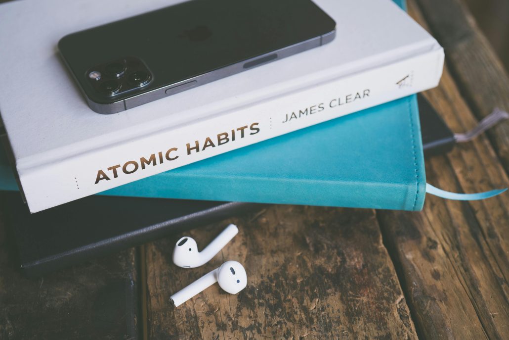 Atomic Habits book on top of a notebook. Strengths and Atomic Habits.